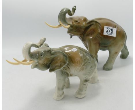 Two Royal Dux elephants: with trunk at salute 