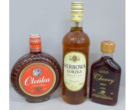 Three bottles; Polish Gold cherry vodka, Olenka cherry vodka and Herbowa Gorzka orange and caramel vodka **PLEASE NOTE THIS L