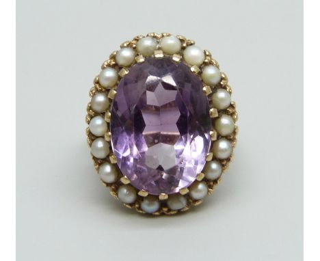 A 9ct gold and amethyst ring with a seed pearl border, a/f some pearls replaced/chipped and shank misshapen, 9.7g, K
