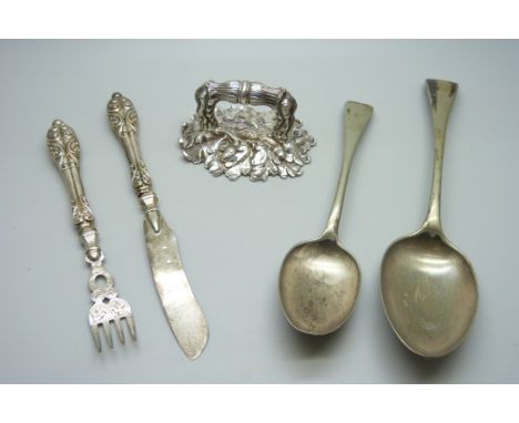 A silver knife and fork set, 60g, two plated serving spoons and a tureen handle