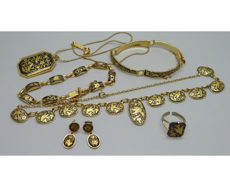 A collection of gold tone jewellery including necklaces, pendants, earrings and a ring
