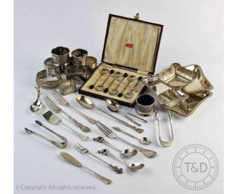 A collection of silver and white metal items, to include; five silver napkin rings and an Indian white metal napkin ring deco