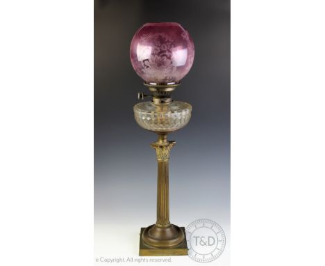 A Victorian brass oil lamp with Corinthian type column and pink glass shade, 71.5cm H, with a selection of vintage enamel kit
