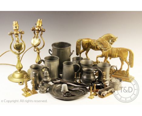 A collection of 19th century and later pewter and brass wares, to include; a Craftsman Pewter bottle sleeve, two brass door p