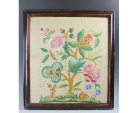 A needlework panel depicting a deer and rabbit beneath a tree, 58cm x 53cm, with a similar needlework picture in wooden frame