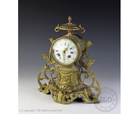 A late 19th century French brass mantle clock, Roman numeral dial with movement striking on a gong, 30cm high (at fault)