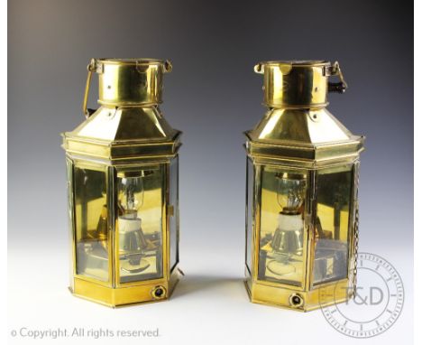 A pair of Alderson & Gyde Ltd of Birmingham brass ships lanterns, each canted front lantern with swivel handle, stamped '1955