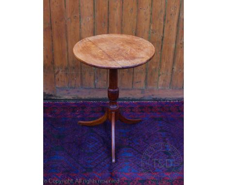 A late George III oak occasional table, with three plank top, on tuned column and tripod base, 73cm H x 54cm diameter 