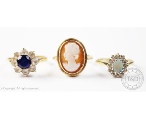 An opal and diamond cluster ring, in 9ct gold setting, a carved shell cameo ring in 9ct yellow gold and a blue and white ston