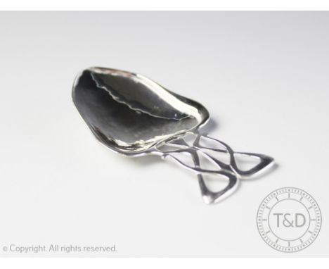 A silver Arts and crafts caddy spoon, Deakin & Francis Ltd, Birmingham 1904, with planished bowl beneath a sinuous form handl