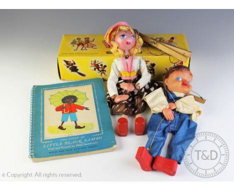 A Pelham Puppet of a girl, with a box, with a Pelham type puppet and a copy of THE STORY OF LITTLE BLACK SAMBO by Helen Banne