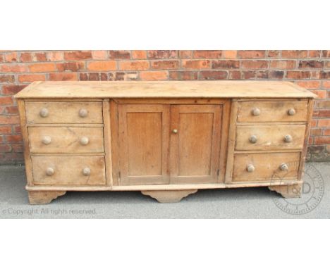 A Victorian and later pine country kitchen dresser, with two cupboards and shelves over two cupboard doors and six drawers, o