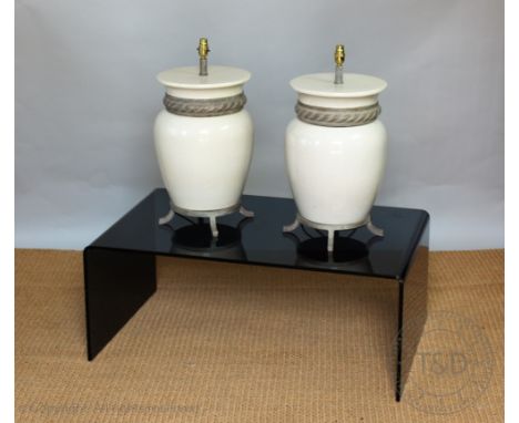 A pair of cream and craquleure glazed lamp bases, with rope twist detail 48cm high with a smokey glass contemporary coffee ta