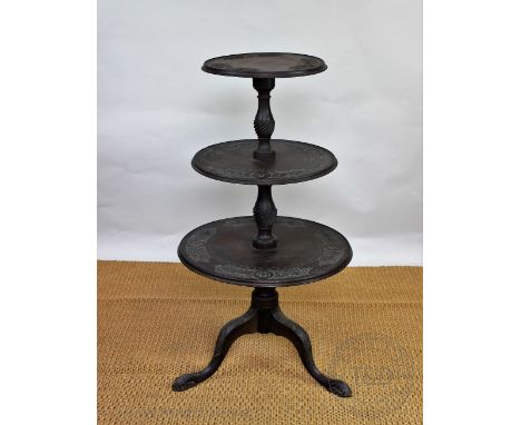 A Victorian carved mahogany three tier dumb waiter, with floral detailing, on tripod base, 109cm H