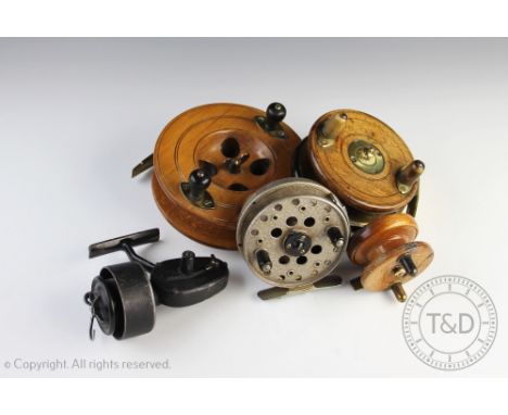 A vintage walnut sea reel, the 11cm diameter reel with brass star back centre pin, with a larger beech sea reel, a smaller se