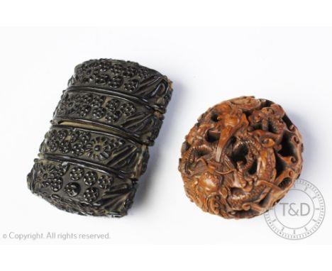 A Japanese carved box wood netsuke, depicting a dragon and flaming pearl, 5cm diameter, along with an ebonised four piece inr