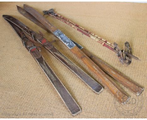 A pair of vintage wood skis, the taller 202cm and stamped 'Lillywhites', with a pair of vintage ski poles (6)