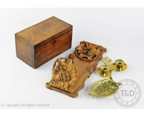 A 19th century oak tea caddy, 23cm wide, with a Black Forest type carved soft wood book slide, a brass chamber stick and an o