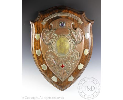 A large Edwardian silver plate and copper mounted trophy shield for 'First Aid Workshops' 'The Rowden Ambulance Challenge Shi