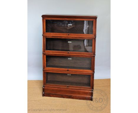 A Globe Wernicke walnut four section bookcase, on plinth base, 139cm H x 88cm W x 25cm D