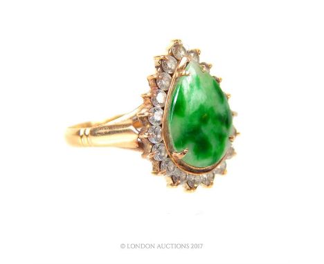 An 18 ct yellow gold, green, mottled jade (teardrop shape) and diamond ring, composed of a central, mottled green jade stone 