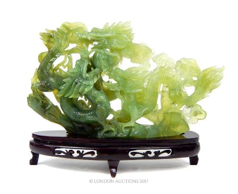 An exquisite, large, Chinese, early 20th century, translucent jade carving depicting three, four-clawed, ferocious, dragons c