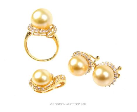 An 18 ct yellow gold, diamond and champagne-coloured South Sea pearl suite comprising of a fine dress ring centrally set with