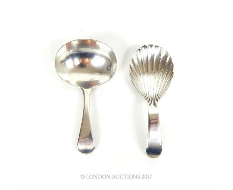 Two George III hallmarked sterling silver caddy spoons, one having a shell form bowl, assayed in London in 1800, the other as