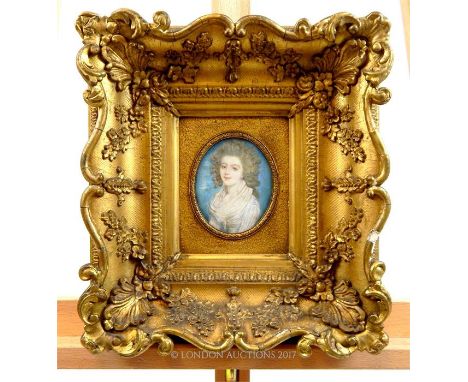 A late 18th century oval miniature portrait of a beautiful young woman, contained in a swept gilt frame, overall 30 x 28cm.