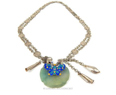 An early 20th century, Chinese, silver, enamel and jade pendant featuring a stylised blue, green and yellow cloisonne enamel 