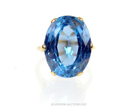 A 1920's, impressive, large blue topaz and yellow gold cocktail ring, composed of a very large faceted blue topaz within a si