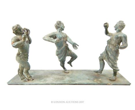 An antique verdigris bronze figural group depicting three Classical revellers, including Pan, raised on a rectangular base, 1