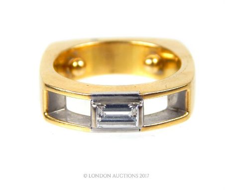 A contemporary, high carat yellow gold and emerald-cut diamond ring with a distinctive, squared, chunky shank and centrally s