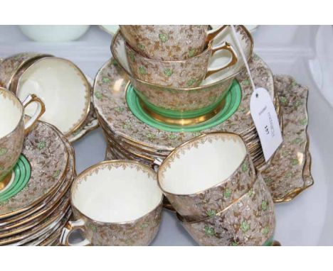 TUSCAN CHINA TEA SERVICE
each of octagonal form, decorated with spiraling gilt pattern with green clover decorations, green p