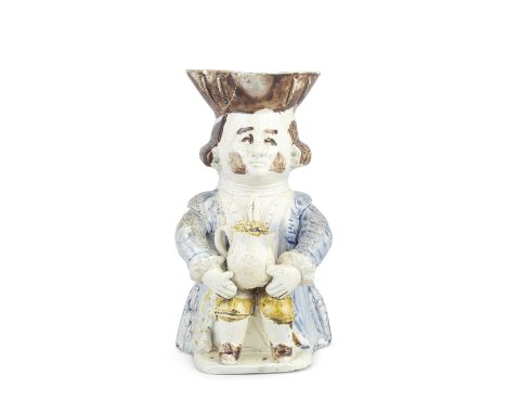 A very rare Toby Jug from the 'Midshipman Family', circa 1785Attributed to Jacob Marsh, modelled seated with a foaming jug gr