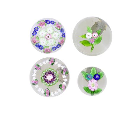 Two Clichy flat bouquet paperweights and two Clichy patterned millefiori weights, circa 1850The first with a central posies o