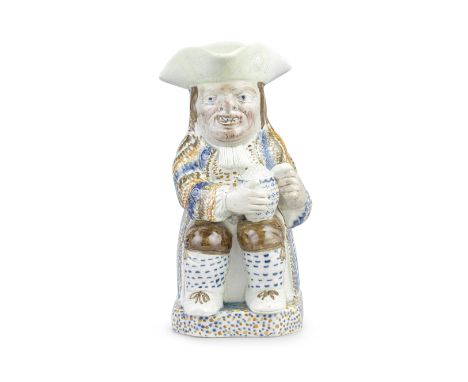 An unusual Prattware Toby jug, circa 1800Of traditional form, modelled seated and holding a patterned foaming jug with both h