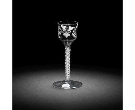A rare wash-enamelled airtwist wine glass, circa 1760The ogee bowl painted in a thin white enamel with a branch of fruiting v
