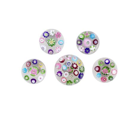 A small Clichy spaced millefiori paperweight and four miniature weights, circa 1850The first with an assortment of eighteen b