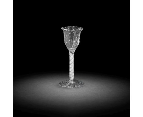 An unusual 'ladder' moulded airtwist wine glass, circa 1755The lipped ogee bowl and the conical foot both with distinctive la