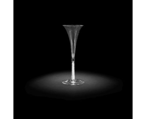 A rare opaque twist toasting glass or flute, circa 1765-70Of very slender drawn trumpet shape, the thin double-series opaque 