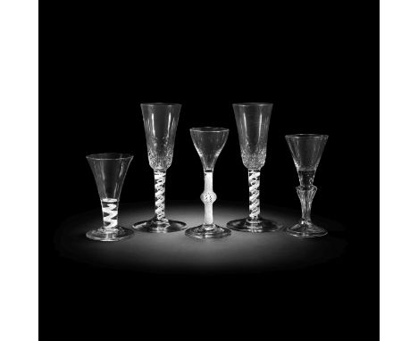 Four opaque twist glasses and a moulded stem wine glass, circa 1750-65Comprising a pair of ale flutes, the tall round funnel 