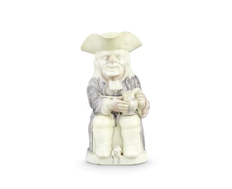 A creamware 'Step' Toby jug, circa 1785-90Of traditional form, seated and holding a jug in his left hand and a pipe in his ri
