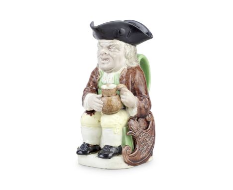 A rare Wood Family 'Shield' Toby jug, circa 1785Based upon the traditional form, seated and holding an empty jug in both hand