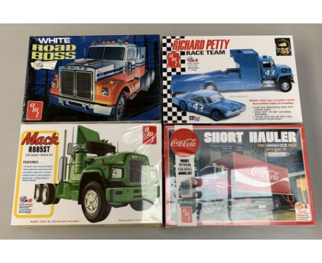 Four AMT 1:25 scale plastic model kits, all trucks: 1039.06 Mack R685ST; 1072/06 Richard Petty Race Team; 1048/06 Coca-Cola S