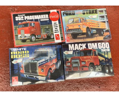 Four 1:25 scale plastic model kits, all trucks, by AMT and MPC: MPC859/06 Mack DM600 Tractor; AMT1090/06 Coca-Cola Peterbilt 