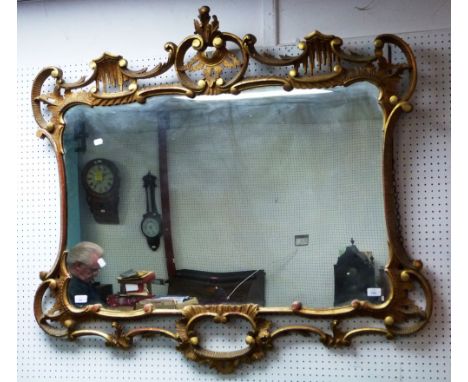An early 20thC Chippendale-style giltwood framed Mirror, the shaped rectangular plate set within a scrolling openwork Rococo 