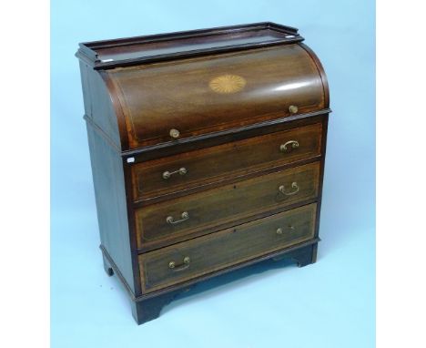 An Edwardian inlaid mahogany cylinder top Bureau, the fitted interior with slide out writing surface inset with tooled gilded