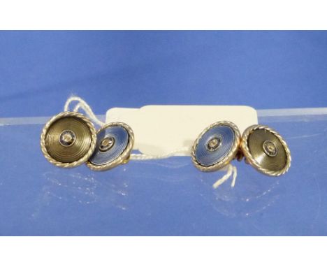 An attractive pair of double Cufflinks, one side in white gold with swirls and rope border, the centre with calibre cut sapph