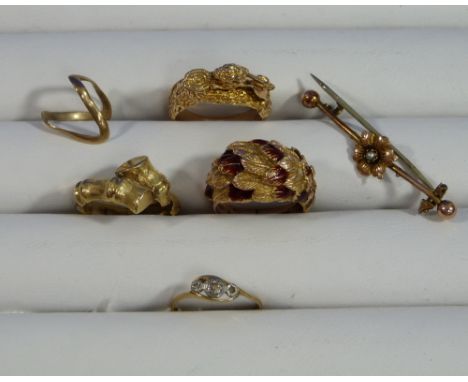 Four Rings, one set three diamond points, one with feathered front in yellow metal and red enamel, one with a lion, one of tw